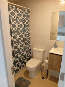 a bathroom with a toilet and a sink at Departamentos JM osorno in Osorno