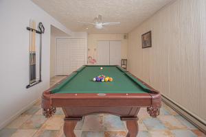 a pool table with balls on it in a room at Swans Nest in Swanton