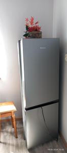 a refrigerator with a potted plant on top of it at U Magdy apartament dla 4 osób 2 par parking w cenie samodzielne zameldowanie klucze w skrytce kod wysyłany przed przyjazdem in Borne Sulinowo