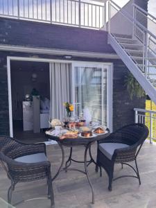 a table with food on it on a patio at Sassi Di Matera Chalés in São Domingos do Sul +9 photos