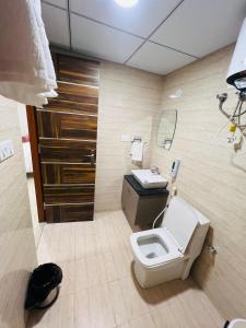 a bathroom with a toilet and a sink at The Sleepy Monkey in Jaipur +7 photos