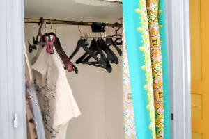 a closet with a rack of shoes in a room at Studio charmant à Sainte Anne avec terrasse - 26 m² in Sainte-Anne