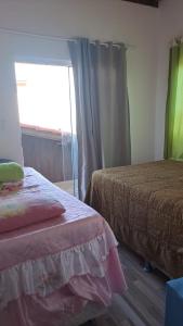 Ένα ή περισσότερα κρεβάτια σε δωμάτιο στο Casa de Temporada tranquila próxima das praias da Guarda do Embaú!Pinheiral! Sonho