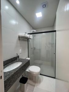 a bathroom with a toilet and a sink and a shower at Bortolotti Residence in Penha