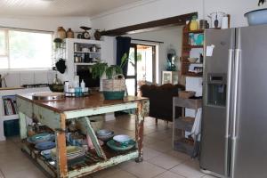 a kitchen with a table and a refrigerator at sonsandsee in Hermanus