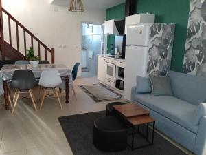 a living room with a blue couch and a table at Maison de vacances Sol & Piper in Gombergean