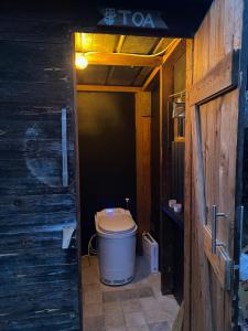 a bathroom with a toilet in a wooden house at Foskvallen Lodge in Särna
