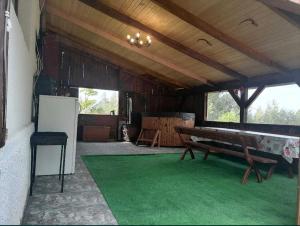a room with a bench and a green rug at Cabana Mădălin&George in Râșca