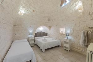 Postel nebo postele na pokoji v ubytování Trulli di Mezza