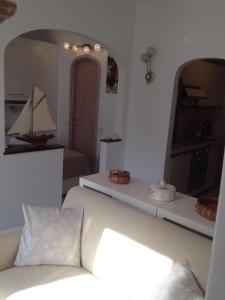 a living room with a white couch and a sail boat on the wall at Civico 3 in Portofino