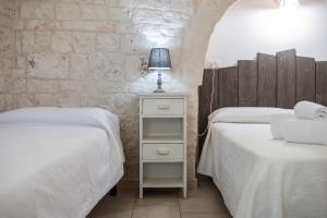 Postel nebo postele na pokoji v ubytování Trulli di Mezza