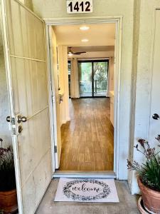 an open door with a sign that says to leave at 2BD Ground Floor Condo in Gated Gardens Pool&Spa in Palm Springs