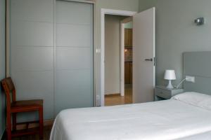 Postel nebo postele na pokoji v ubytování Playa América Angelito B