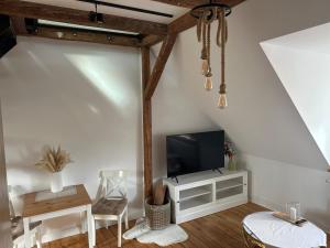 a living room with a flat screen tv on a wall at Loft in Toplage in Paderborn