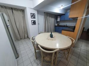 a kitchen with a table and chairs in a room at Quinto Elemento City in Villa Carlos Paz
