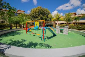 a playground with a slide in a park at GB20 Lindo Apto 3/4 - Genipabu Club House in Monte Gordo