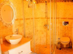 a bathroom with a shower and a sink and a toilet at Selin Hotel in Alaçatı