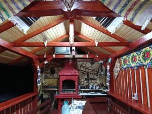 an inside view of a wooden cabin with a fireplace at Casa Vasy in Vatra Dornei