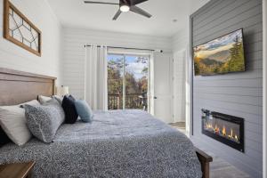 a bedroom with a bed and a fireplace at Enjoy the "Calm On The Water" in a Relaxing Luxurious Pool Cabin on the Lake! in Dandridge +45 photos