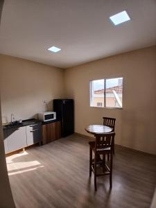 an empty room with a table and a chair at Pousada Lua in São Paulo