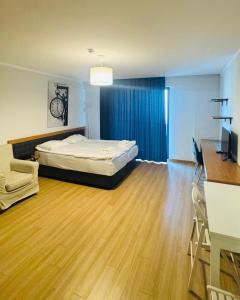 バクリアニにあるOrbi Deluxe Apartmentのベッドとテーブルと机のある寝室