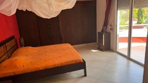 a bedroom with a bed and a fireplace in it at Résidence safari village in Saly Portudal