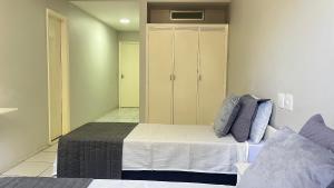 a bedroom with a bed and a closet at Hotel Atlântico in Americana