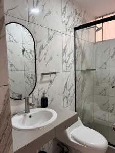a bathroom with a sink and a mirror and a shower at Casa de Playa - Asia - SELENE beach house in Asia