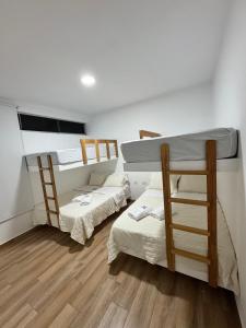 two bunk beds in a room with wooden floors at Casa de Playa - Asia - SELENE beach house in Asia