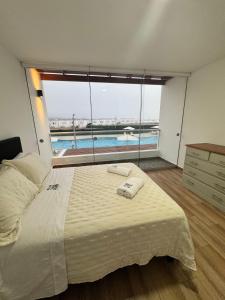 a bedroom with a bed with a view of a pool at Casa de Playa - Asia - SELENE beach house in Asia +28 photos