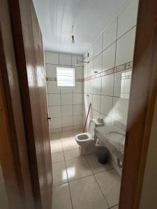 a bathroom with a toilet and a sink at Alojamento Obracamp in Campinas