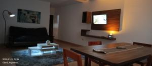 a living room with a table and a couch at departamento céntrico in Oberá