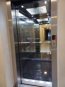 an elevator in a building with a glass door at Forest River Sokobanja in Soko Banja