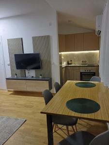 a living room with two tables and a kitchen at Forest River Sokobanja in Soko Banja +7 photos