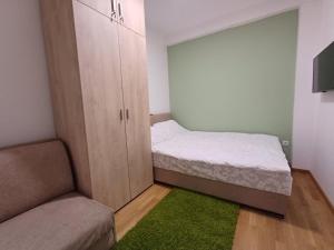 a small room with a bed and a cabinet at Forest River Sokobanja in Soko Banja