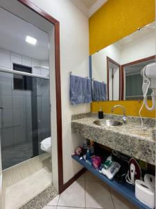 a bathroom with a sink and a toilet at Apto Conquista Imóveis exclusivo para Booking in Vitória da Conquista