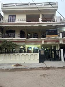 a large building with a fence in front of it at Amara Homestays in Prayagraj