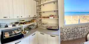 a kitchen with a view of the beach at Gemini Luxury Rooms in Peschici