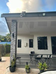 a white house with a picnic table on a patio at Alis786 Apartment in Lautoka