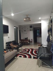 a living room with a couch and a rug at Alis786 Apartment in Lautoka