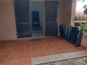 a patio with chairs in front of a house at Casa Azul villa e piscina relax Costa Paradiso Sardegna in Costa Paradiso