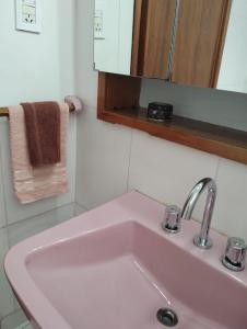 a white sink in a bathroom with a mirror at Alquileres Allen in Allen +11 photos