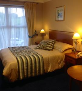 a hotel room with a bed and a window at Fitzgeralds Hotel in Bundoran