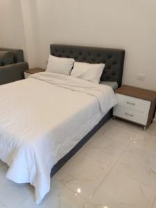 a bedroom with a large bed with white sheets at الغردقه in Hurghada