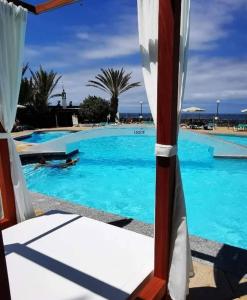 a view of a swimming pool with blue water at Bellavista Basement in Costa Del Silencio