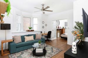 a living room with a blue couch and a table at Private 2 Storey Home with 3BR-2BA by Queen West in Toronto
