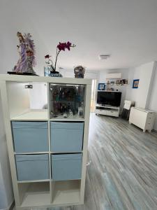 a room with a dresser with blue drawers at Apart. Pineda de Mar-Sea and mountains views in Pineda de Mar