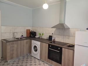 a kitchen with a washing machine and a washer at Athinas Residence in Myrina