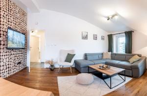 a living room with a couch and a table at Apartmán pod Kněžickým vrchem in Vrchlabí