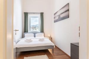 a bedroom with a bed and a window at Apartmán pod Kněžickým vrchem in Vrchlabí
